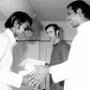 Fr Raymond Ambrose, flanked by Brother Hubert de By, handing a certificate to a student of the communications' training course.