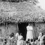 The priest who has come from the central parish addressing catechumens at the entrance of the village's prayer hut.