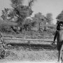 Children from a village walking along a railway track.