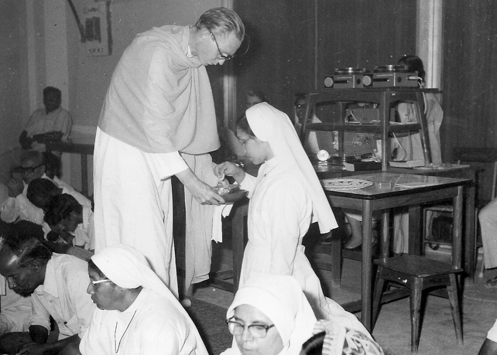 I am offering the tray with consecrated bread and wine, the communicant takes communion herself.