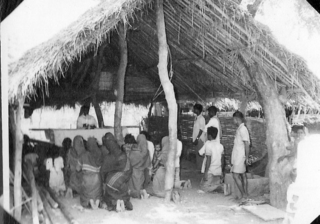 Mass celebrated in an open prayer hut.