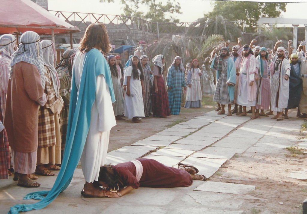 The pharisees throw the woman caught in adultery before Jesus' feet