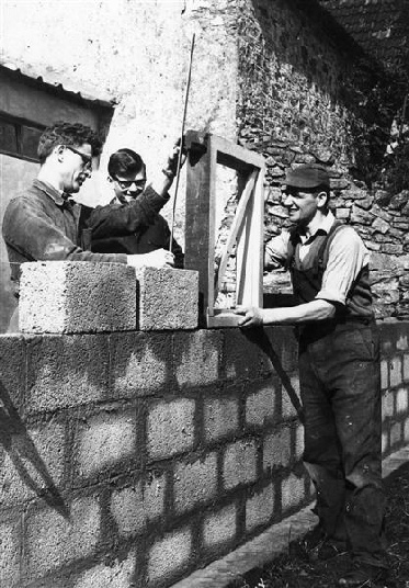 Brother Sjaak van Cruchten (left), teaching two younger brothers.